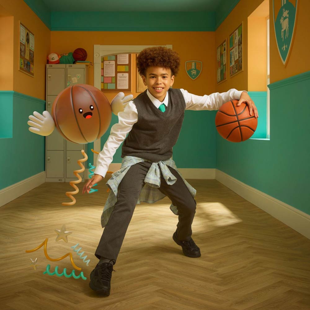 boy in a hall way playing basketball